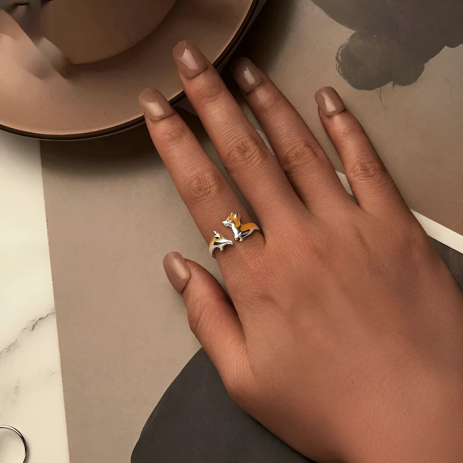Silver ring with a raised cartoon corgi dog design and electroplated colour finish.