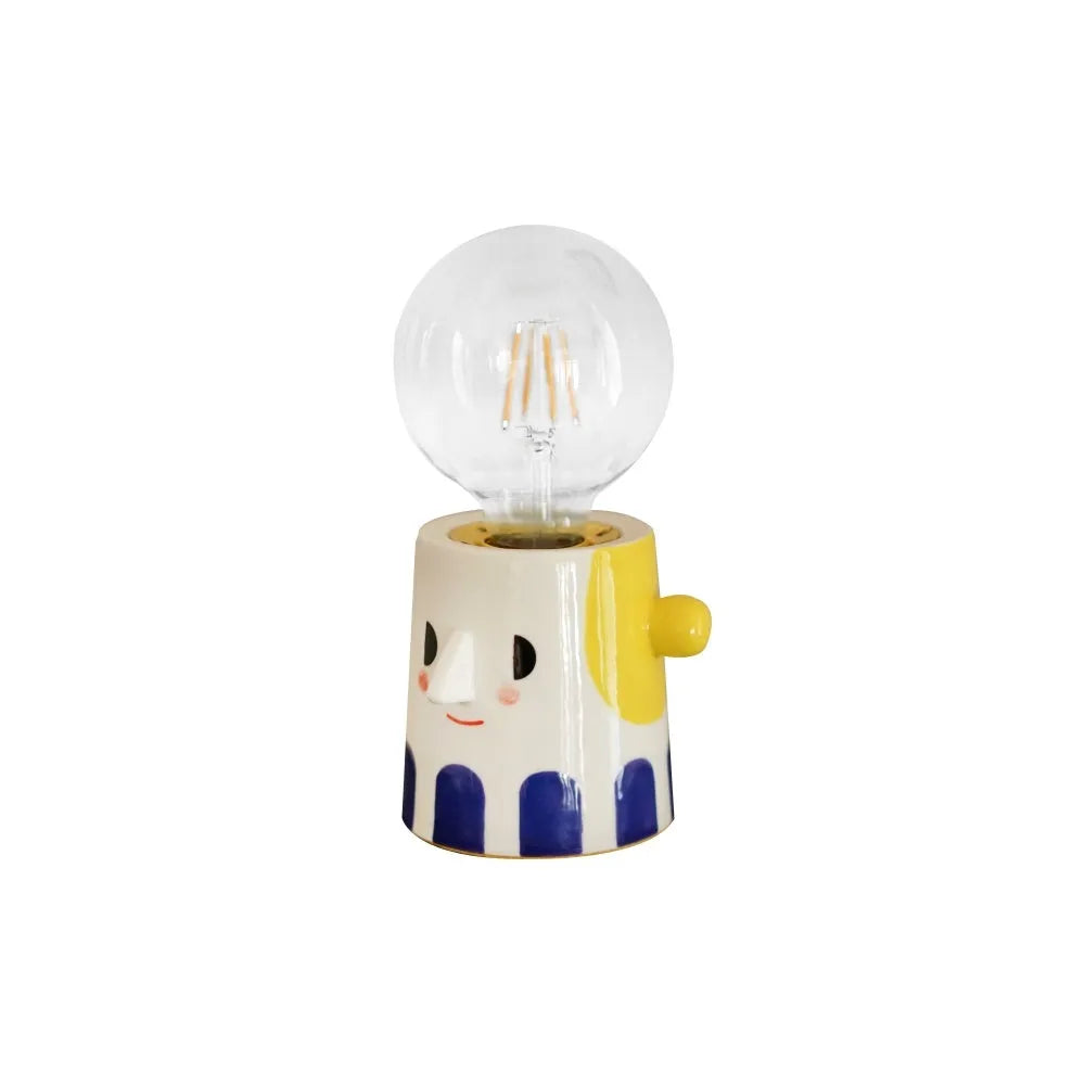 Handmade ceramic bedside lamp with spherical ball headlight shade on wooden nightstand