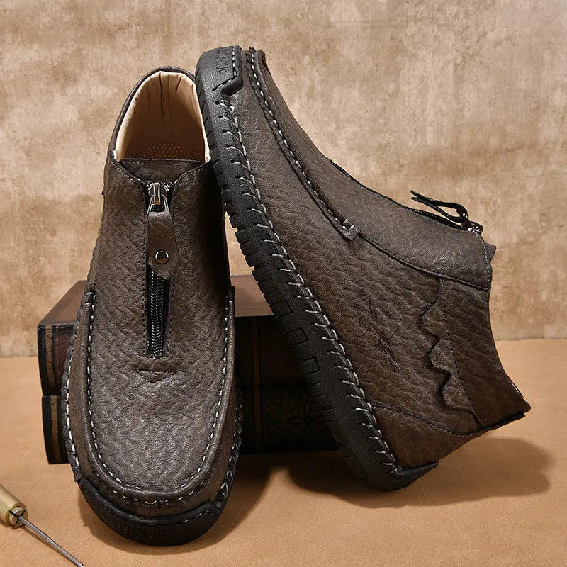 Men's black PU leather slip-on loafers with a round toe and sewn rubber sole on a white background.