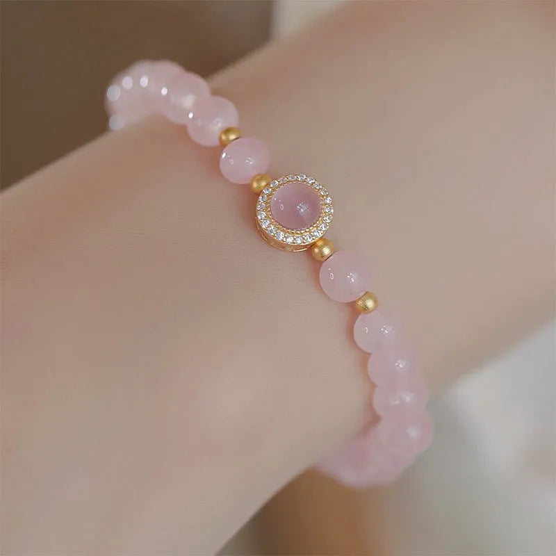 Women's aquamarine crystal bracelet with round geometric beads in mixed materials including natural pink crystal and imitation pearl
