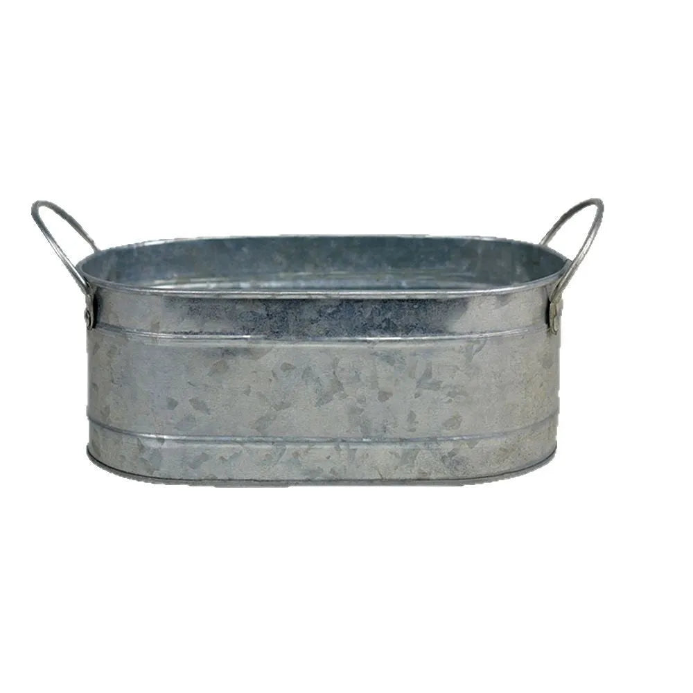 Galvanised iron succulent flowerpot with rustic finish on a wooden desk.