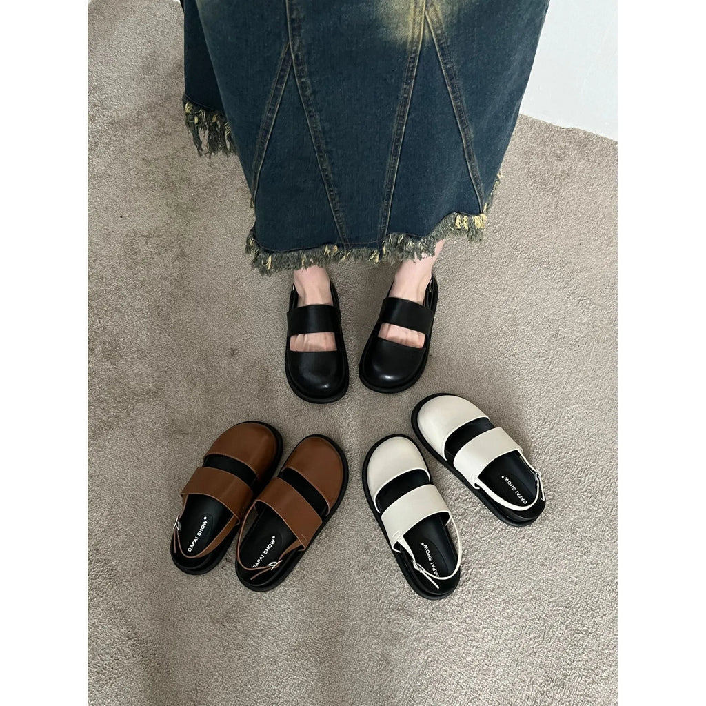 Retro women's sandals with a closed toe, ankle strap buckle, and platform sole in apricot colour.