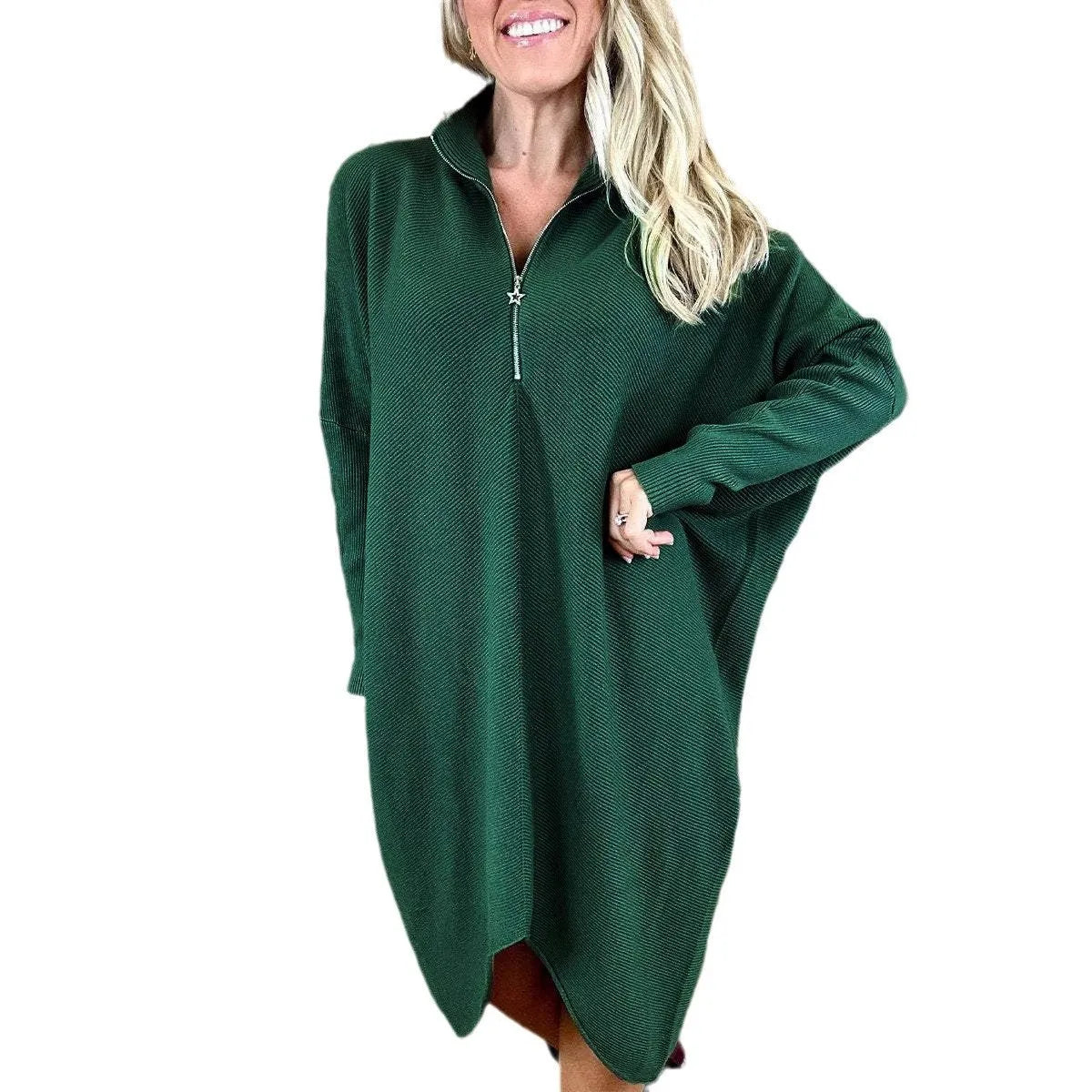 A woman wearing a solid colour loose knitted dress with raglan sleeves, shown in one of five available colours.