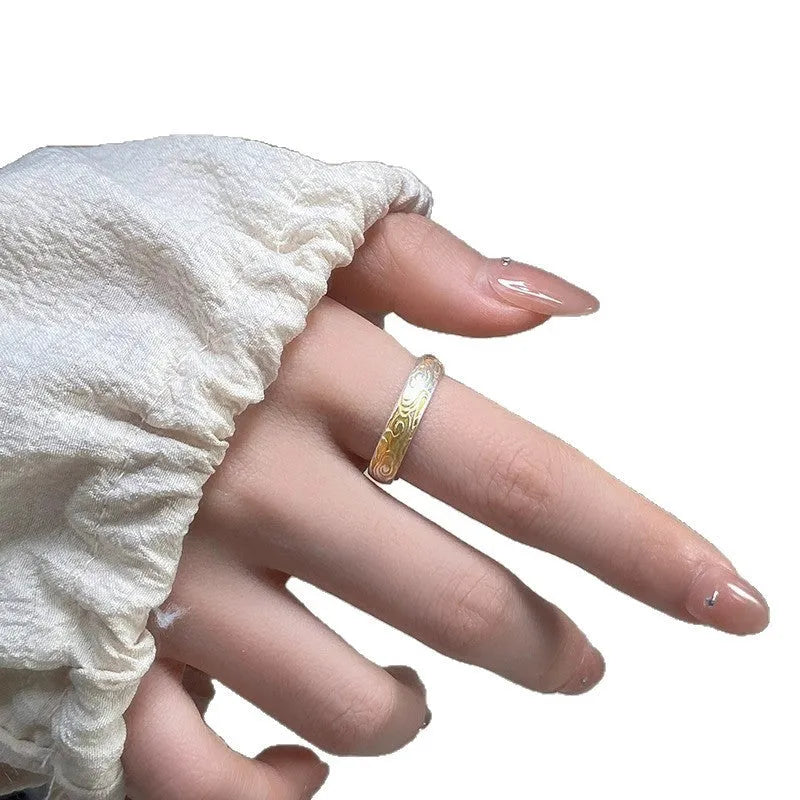 Geometric white copper open ring with silver and gold electroplated Xiangyun pattern.