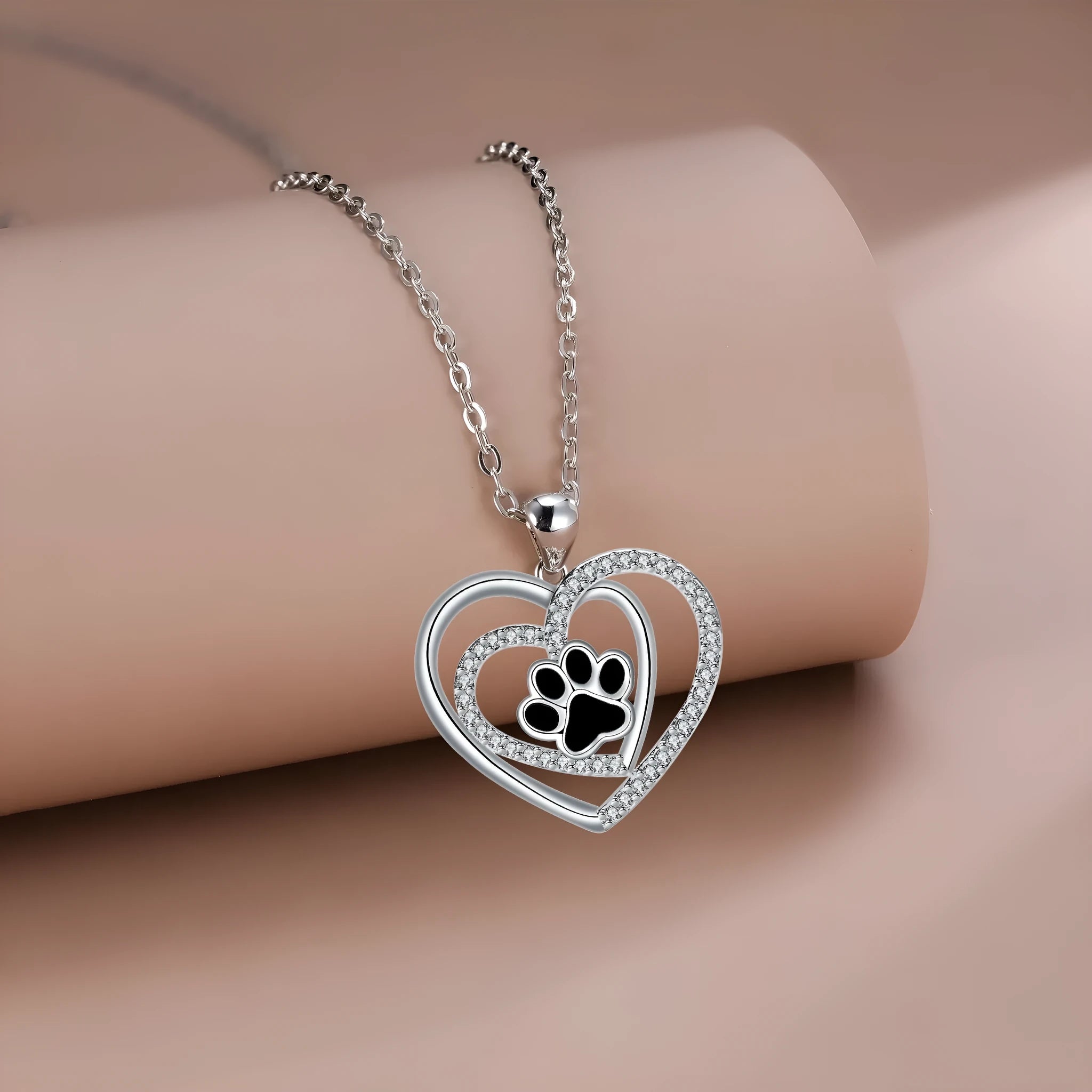 Electroplated copper necklace with heart-shaped dog paw print pendant on cross chain