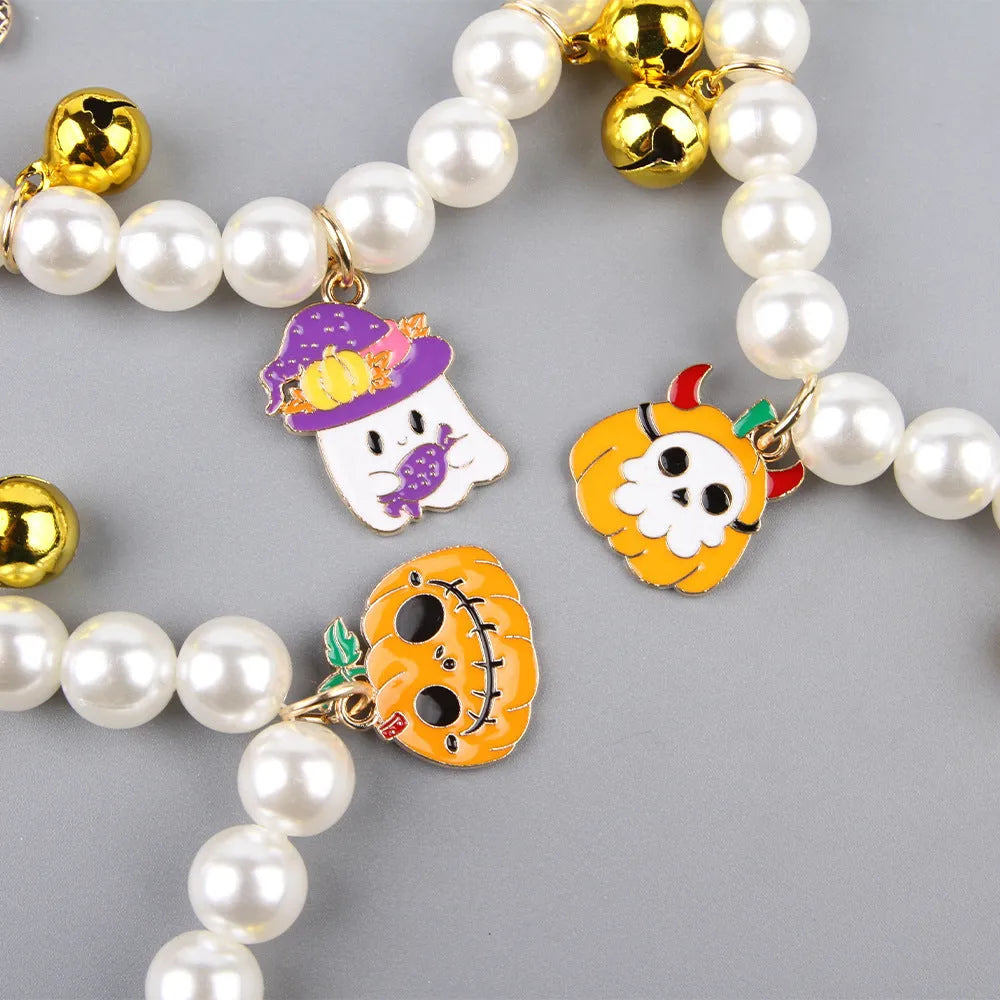 Halloween cat collar with simulated pearl necklace and a central pumpkin charm decoration.