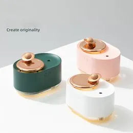 Green rotating planet-shaped USB humidifier with night light on a desk.