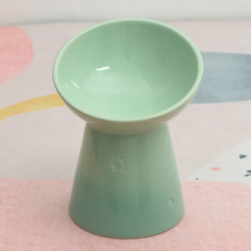 Ceramic anti-tumble pet bowl for dogs and cats with high foot and neck protector.