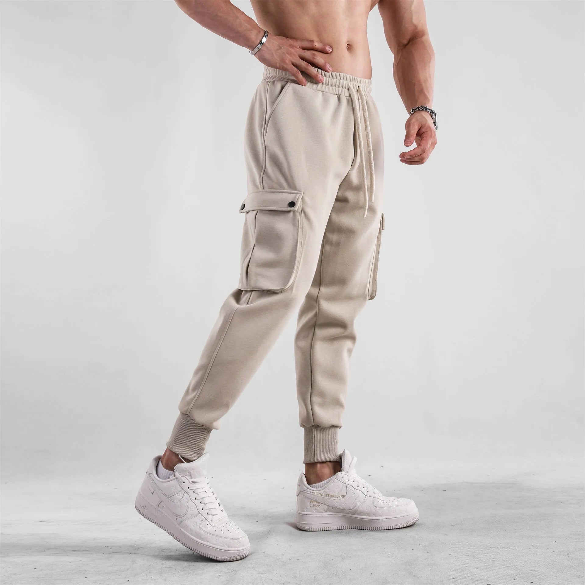 Men's loose fit American sports trousers with ankle ties in apricot colour showing multi-pocket design