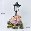 Decorative hexagonal solar garden lamp with animal sculpture design on patio.