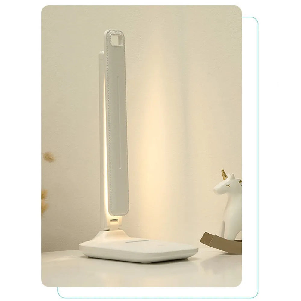 White USB rechargeable bedside lamp with touch dimming control on a wooden table.