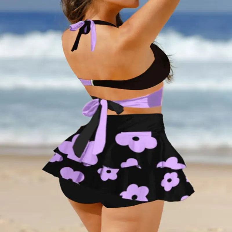 Purple women's bikini set showing lace-up backless top and high-waist briefs with a split skirt.
