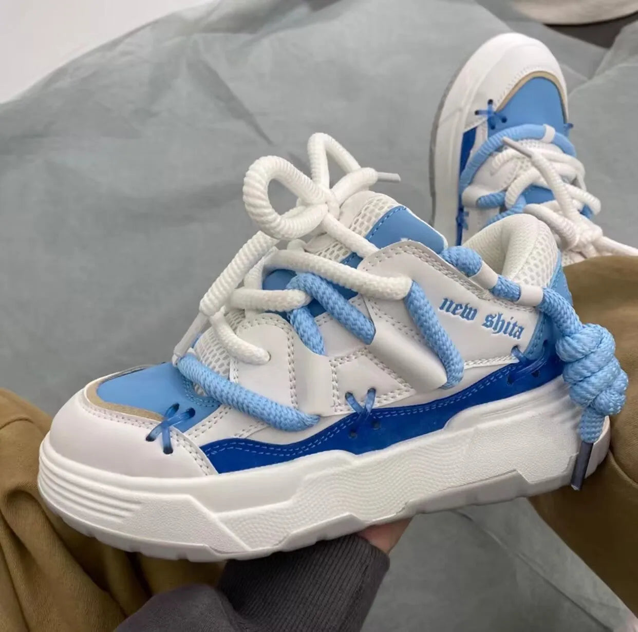 Women's grey chunky platform sneakers with thick rubber sole and lace-up front