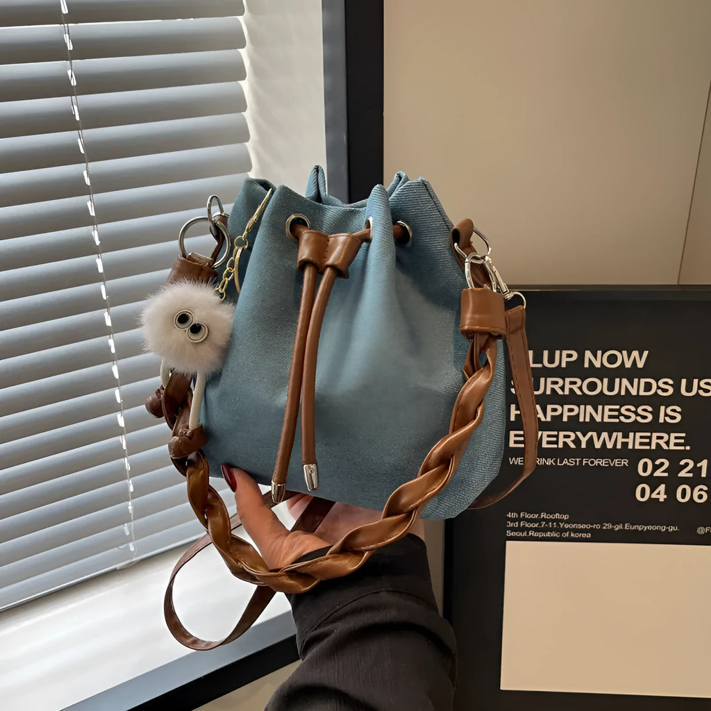Blue one-shoulder cross body bucket bag with sandwich pocket compartments