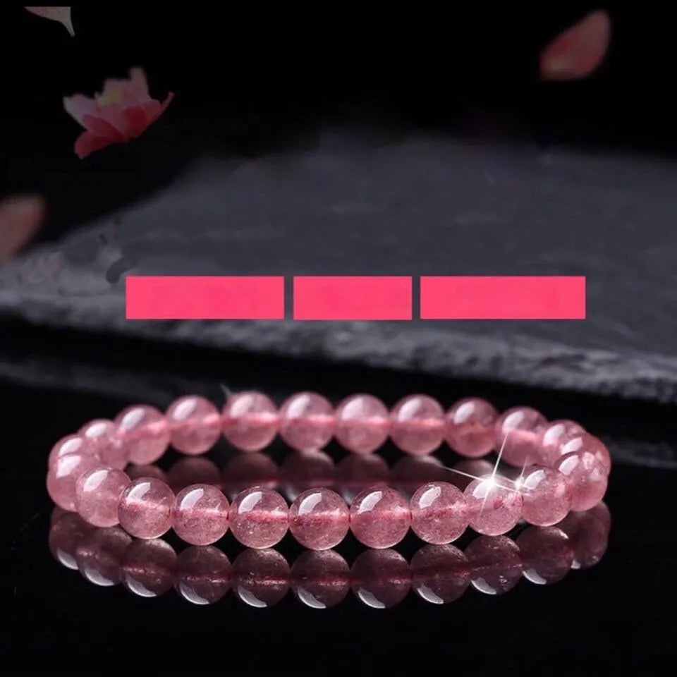 Women's adjustable bracelet with mixed-size polished strawberry quartz crystal beads.