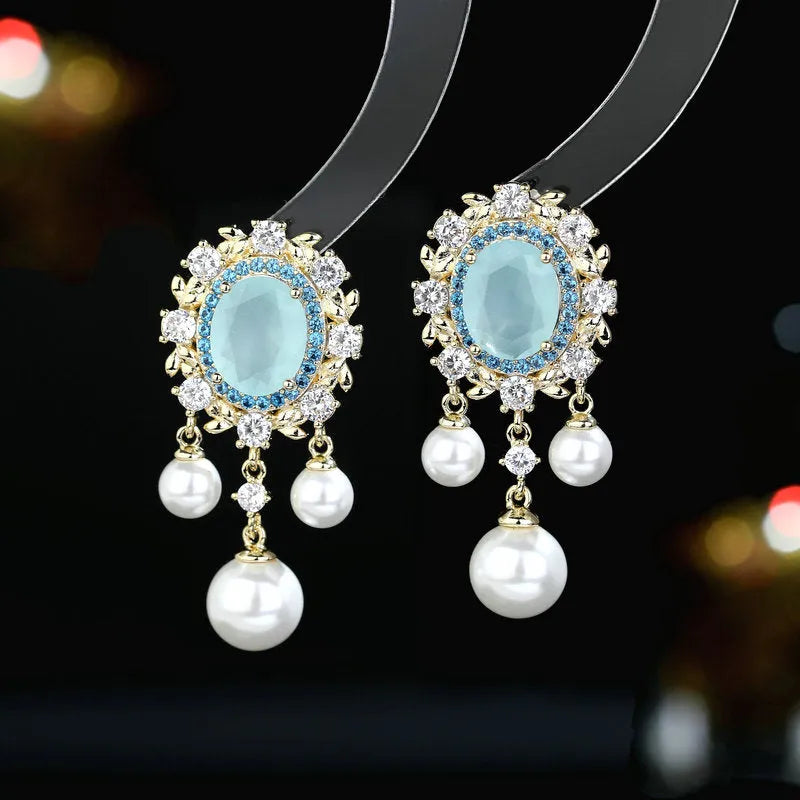 Oval geometric copper earrings with inlaid zircon centre and white pearl tassel drop in light purple colour.