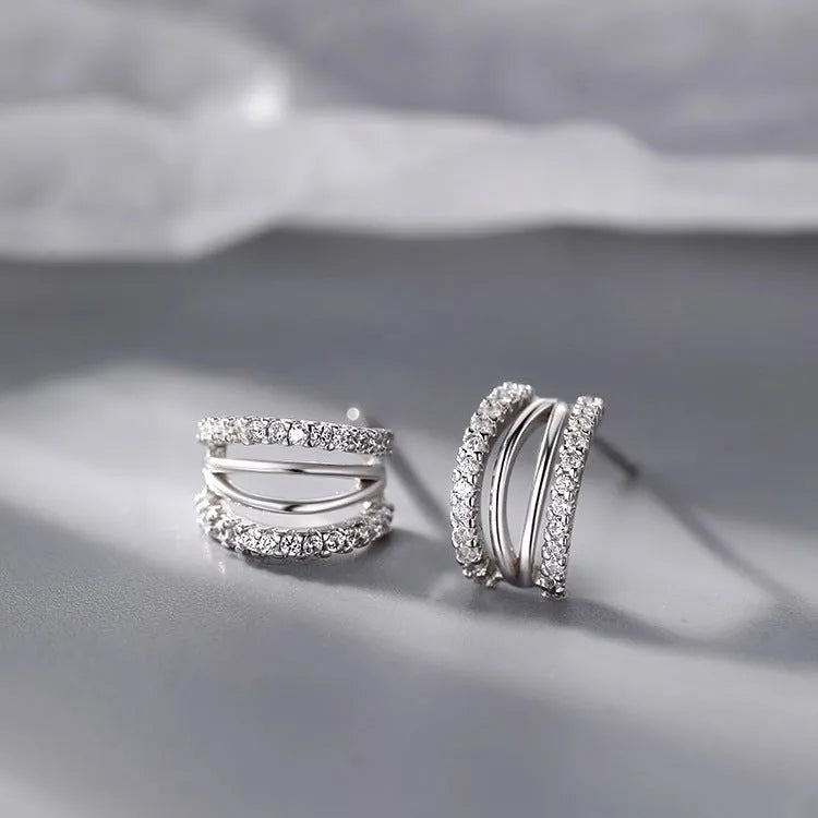 Pair of geometric-shaped 925 silver earrings with silver needle posts, shown in three available sizes.