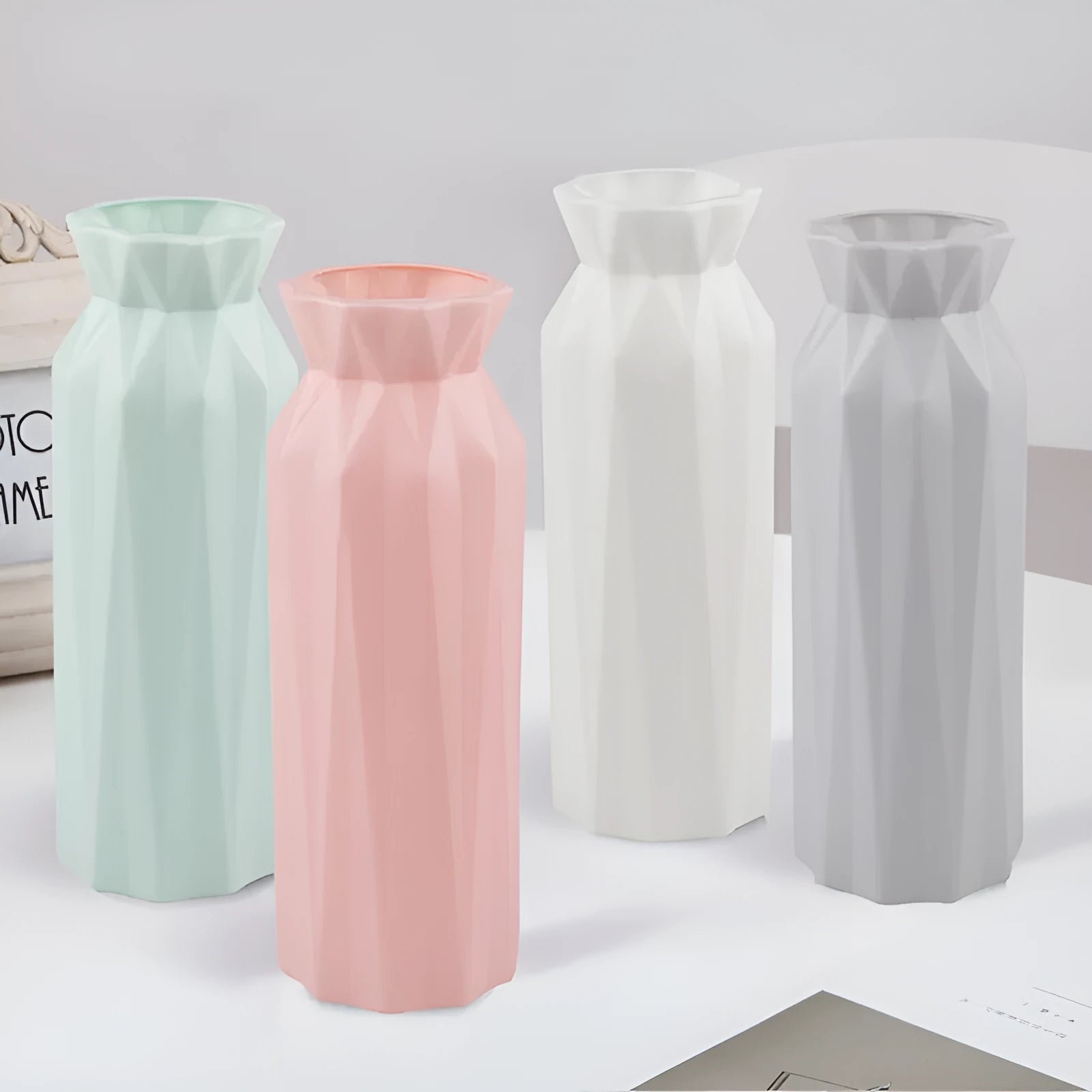 Grey melamine plastic vase with a wide 7.2cm base on a wooden table.
