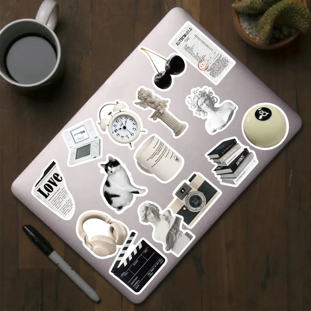 61 black and white waterproof PVC stickers for laptops and phones on a sheet.
