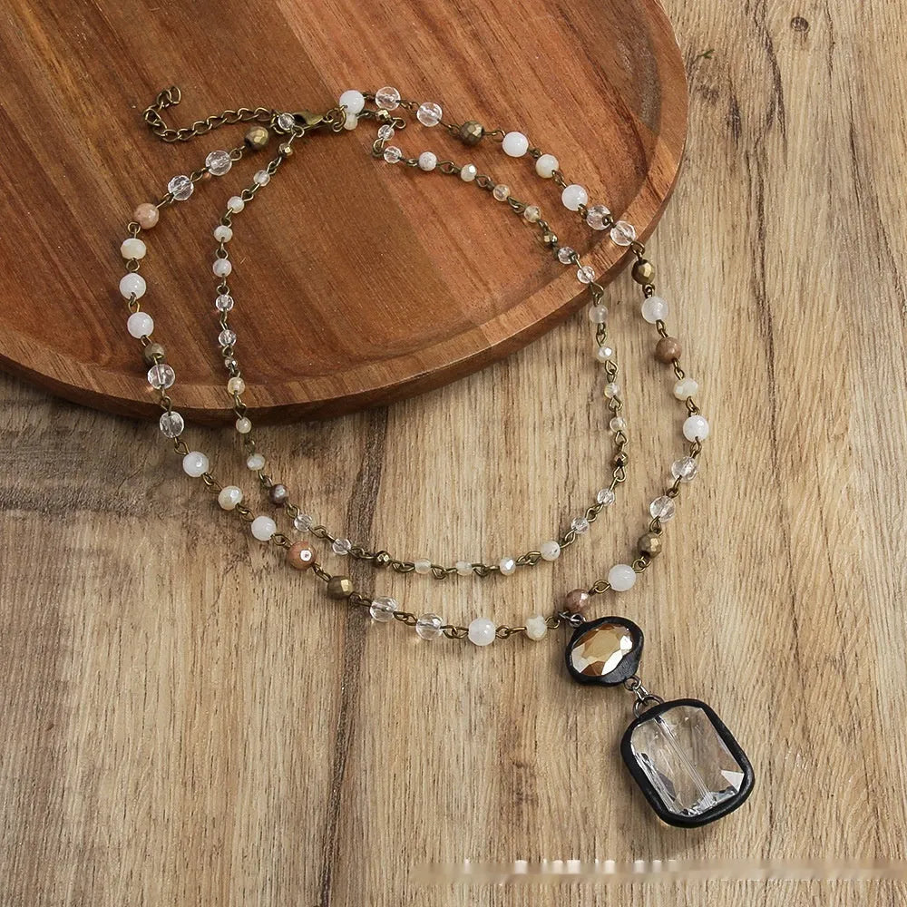 Two-layer tribal style necklace with glass and stone pendants on adjustable chain