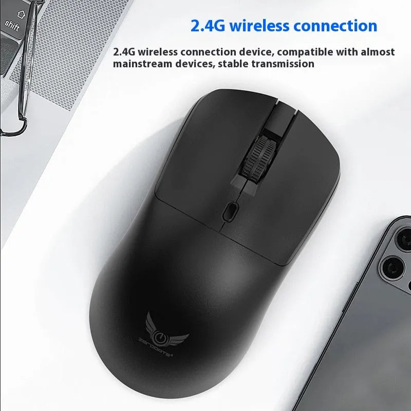 Black wireless mouse with three side buttons on a desk next to a laptop