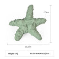 Blue and green rubber dog chew toy shaped like a deep sea shark, conch, and starfish.
