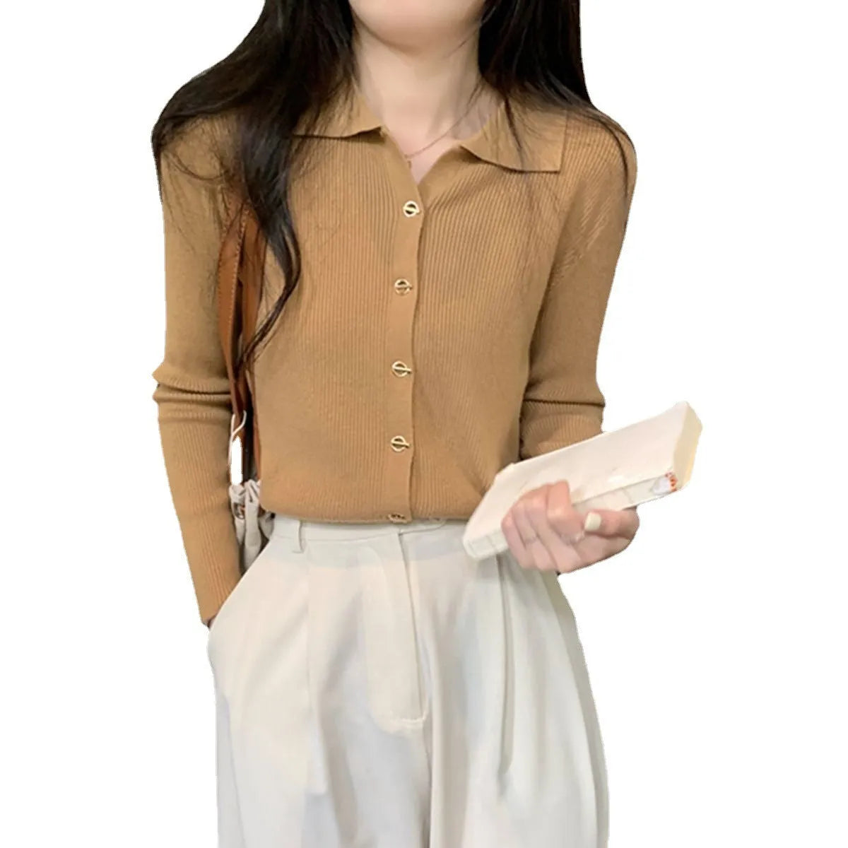 A loose-fitting, long-sleeved beige knitted cardigan for women, made from viscose fibre.
