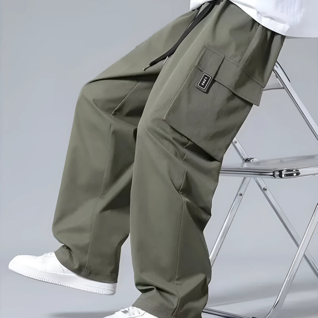Boys straight cargo pants in army green with large side pockets and drawstring waist on white background