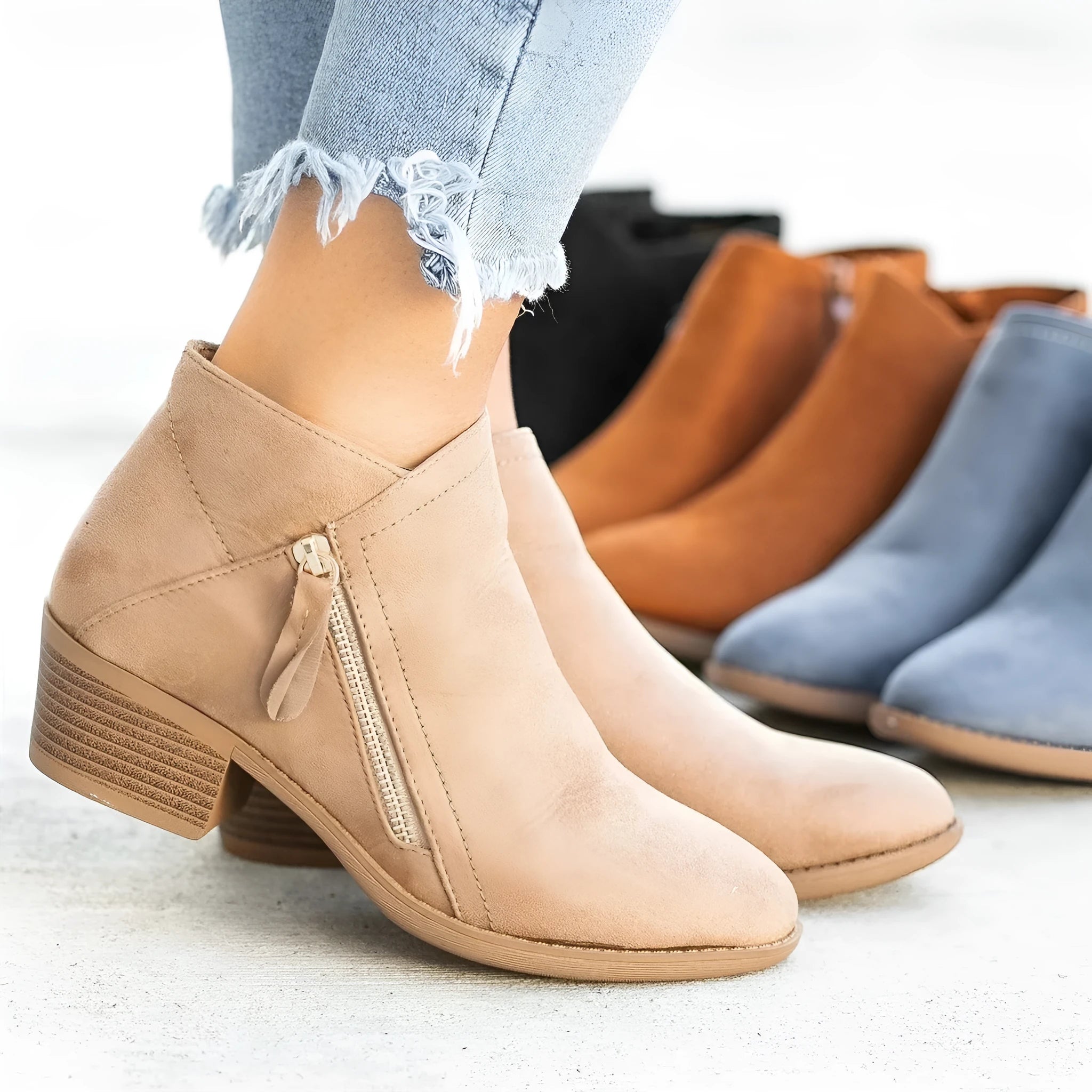 Blue women's suede ankle boots with a side zipper closure and a lightweight composite sole.