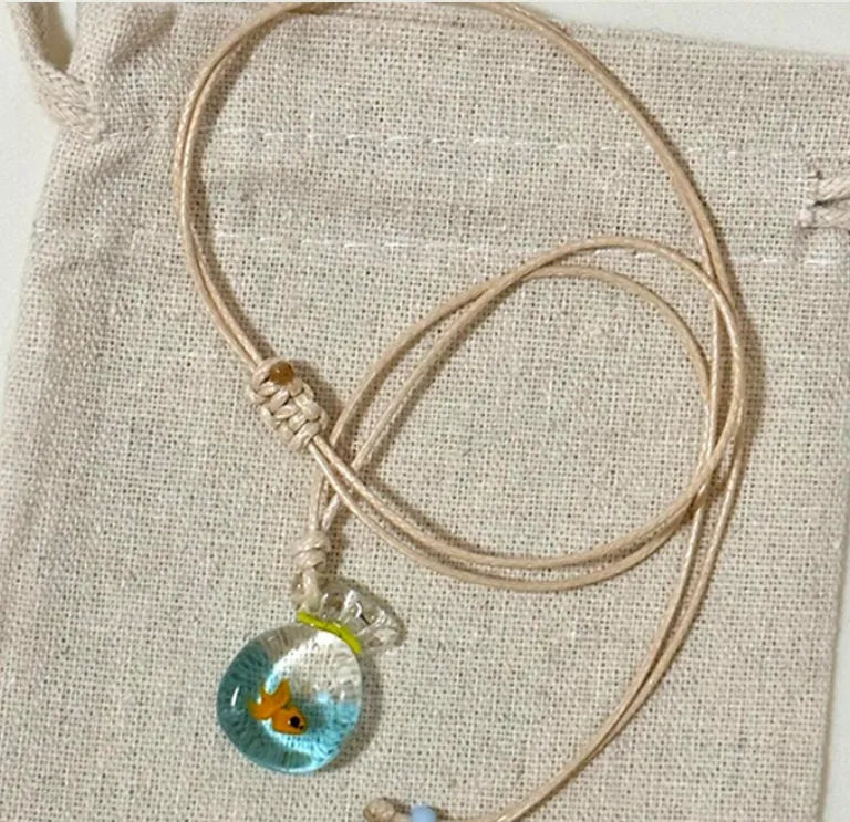 Women's joker charm pendant necklace in coloured glaze on a cotton and linen clavicle chain.