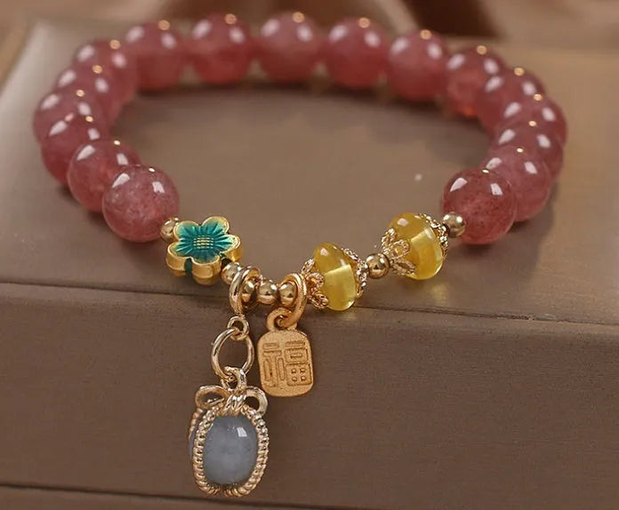 Natural Strawberry Quartz beaded bracelet with rhinestone accents on red alloy base
