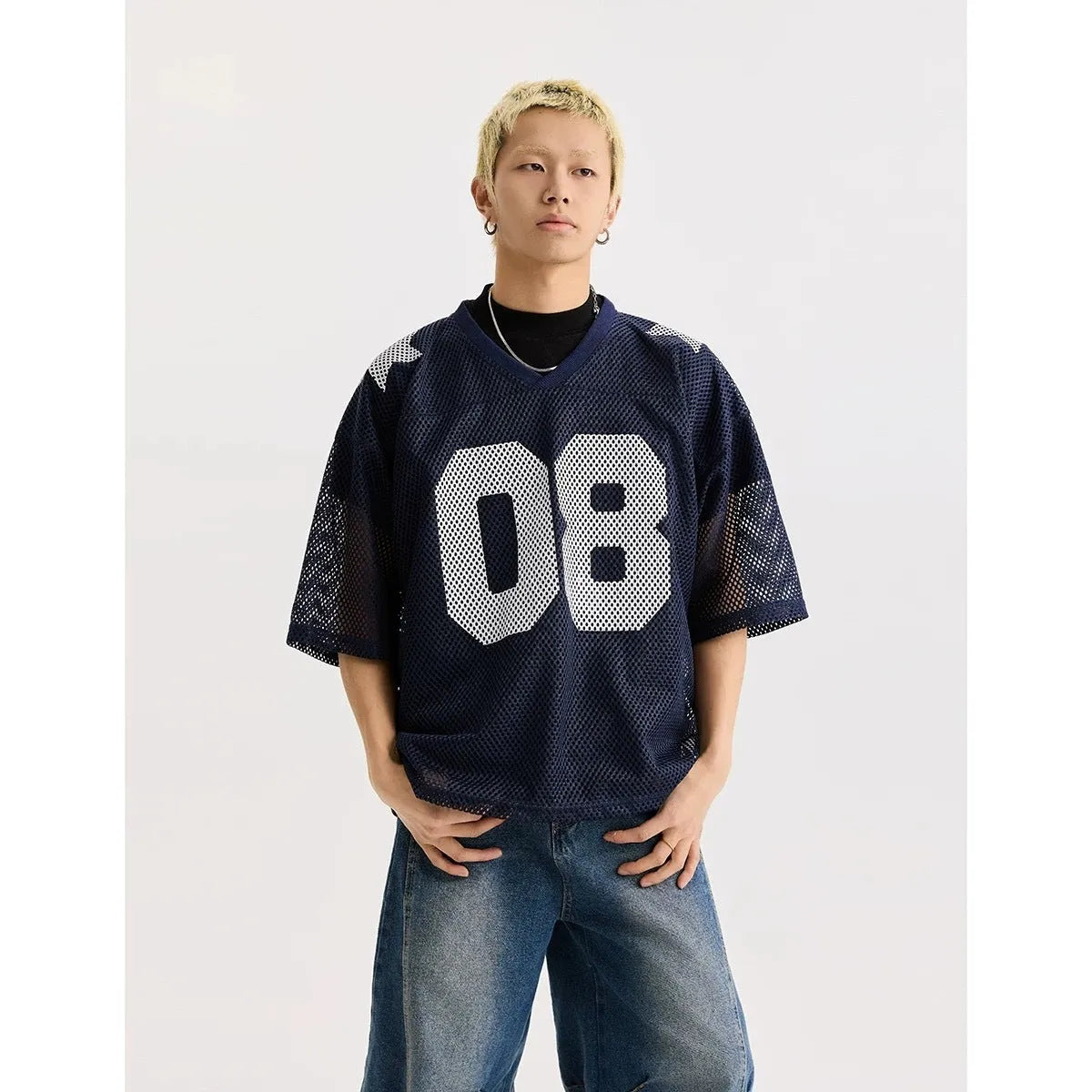 Loose fit black half sleeve pullover shirt with white letter pattern design on the front.