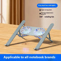 Silver aluminium laptop stand with twin cooling fans in folded position beside notebook computer