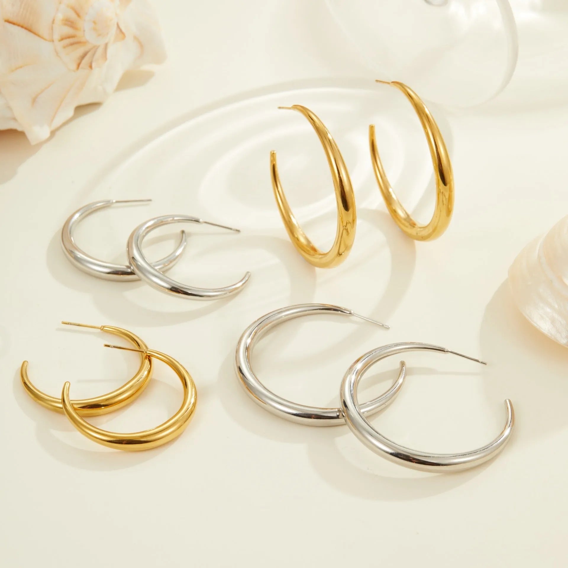 Geometric round titanium steel hoop earrings with 18K gold plating in large and small sizes