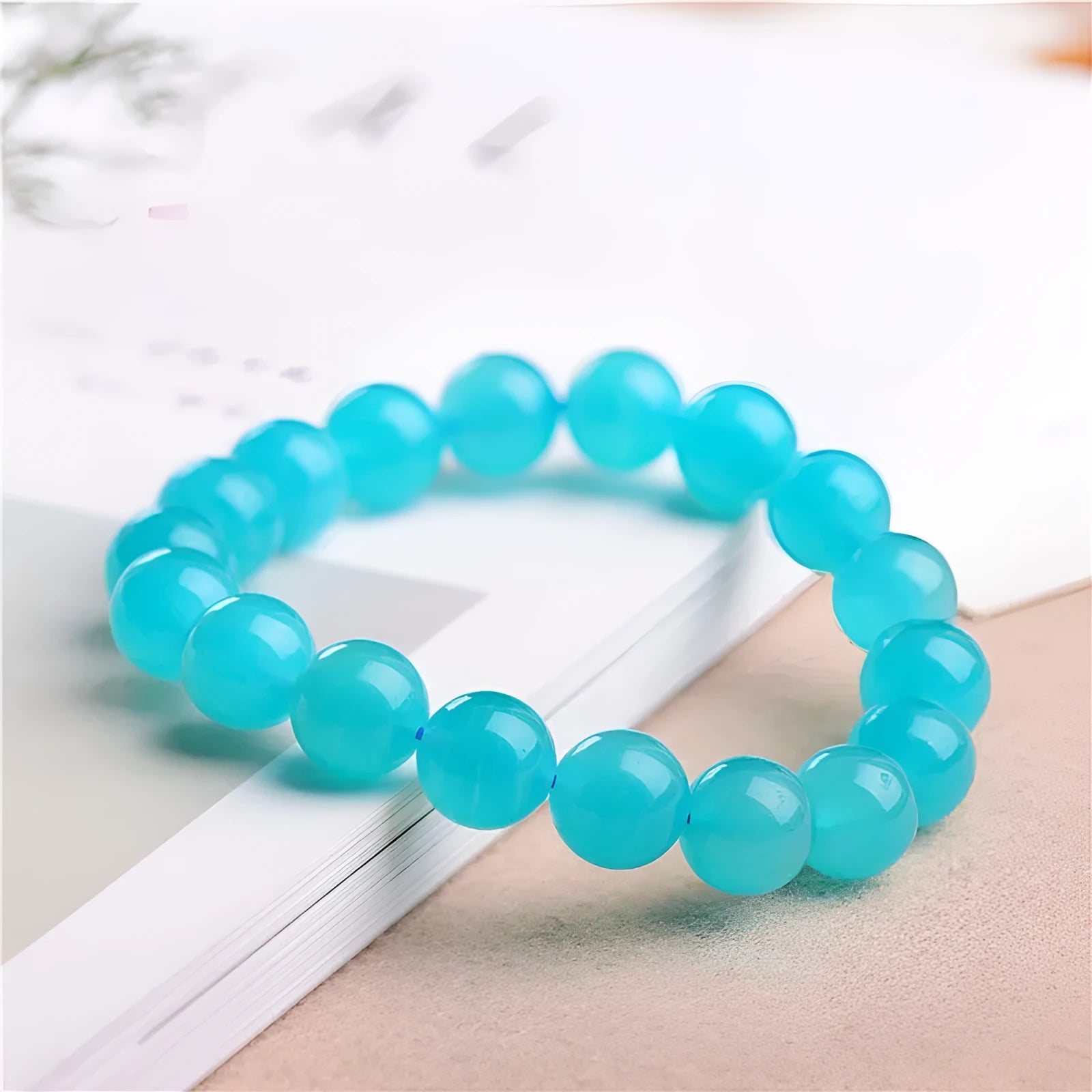 Polished Amazonite scattered beads in ice colour with size options for jewellery making next to crystal bracelet