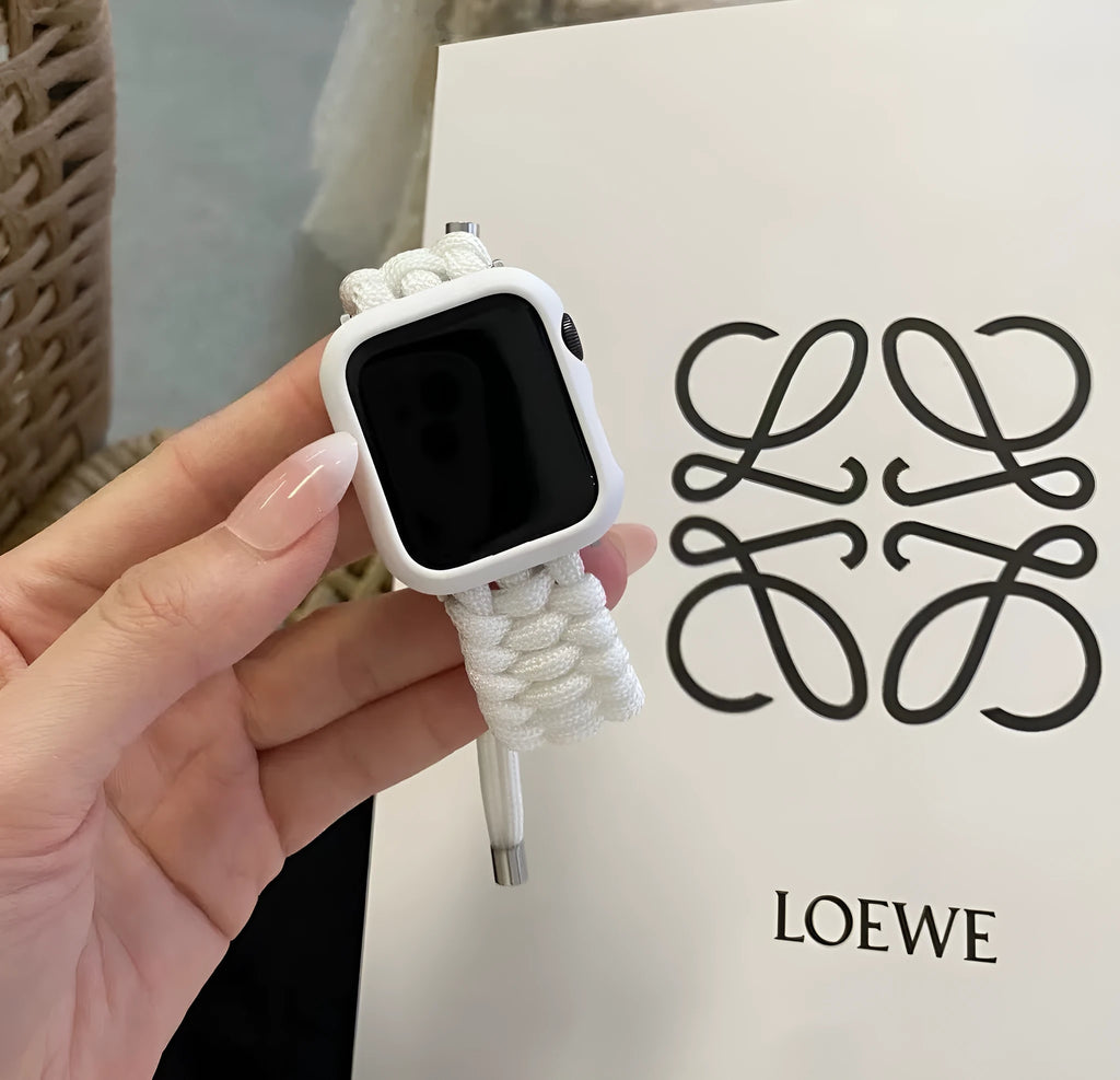 Paracord braided smartwatch strap in black shown next to an Apple Watch.