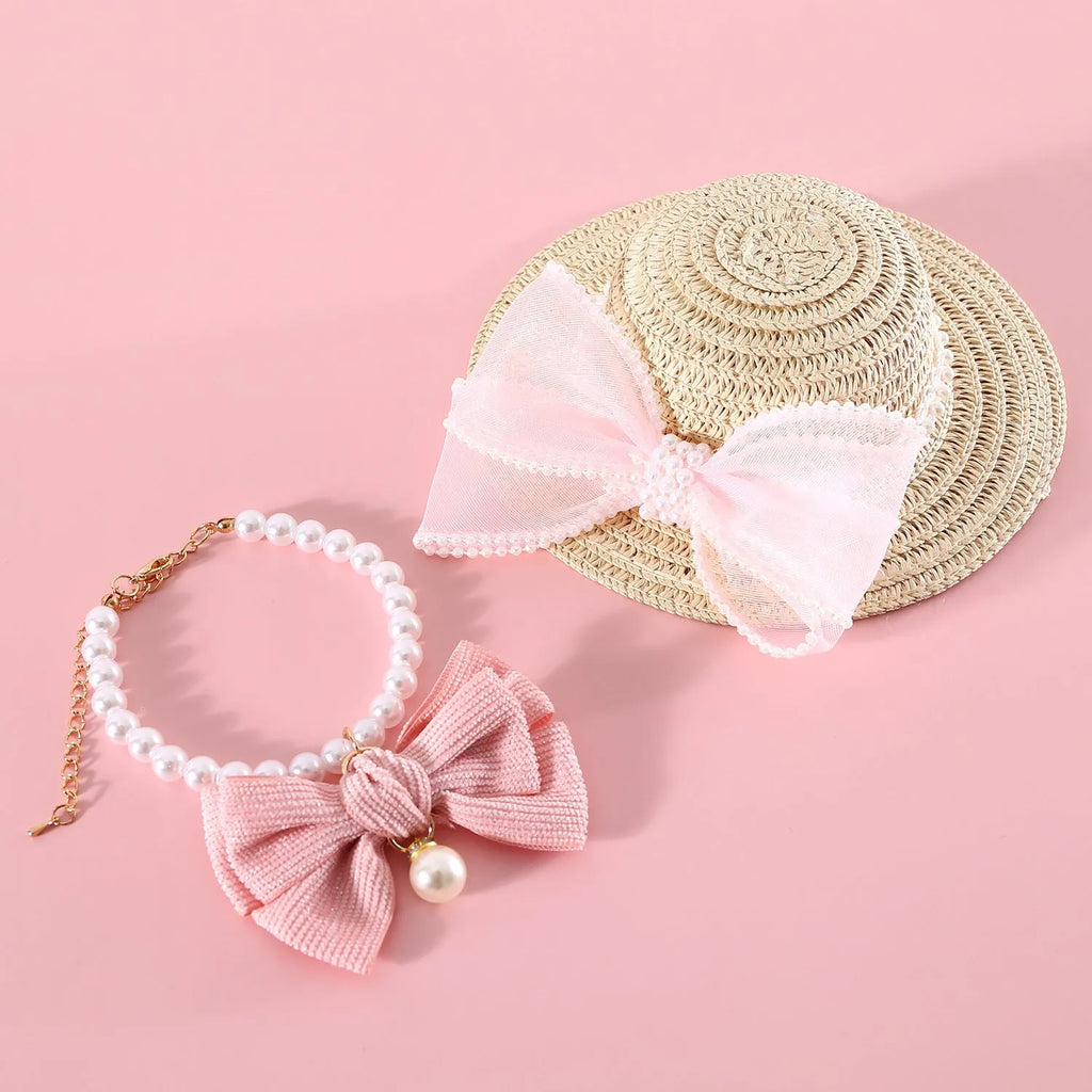 Pet cat wearing woven straw hat with pearl bow decoration in seasonal colour option