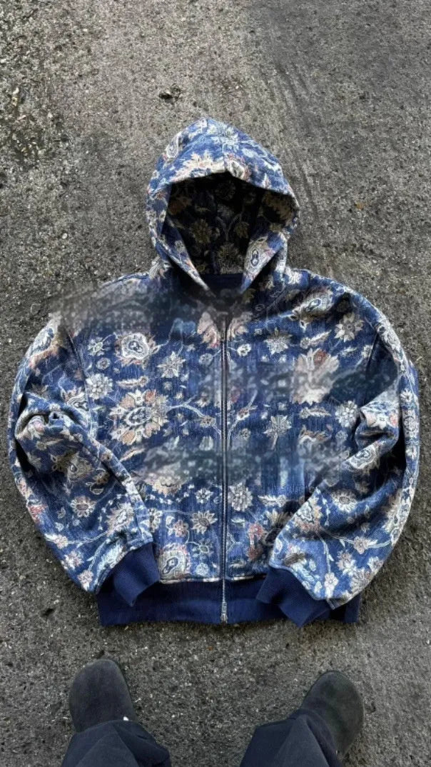 Man wearing a blue loose hooded zip-up polyester coat for casual autumn wear.
