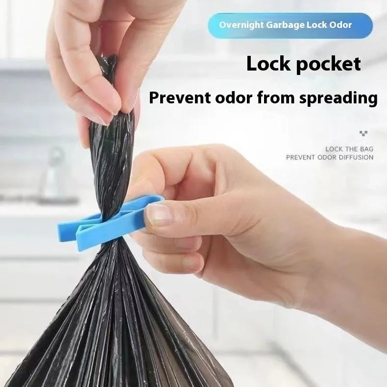 PP plastic bin bag fixing clip attached to a rubbish bin rim holding a liner in place.