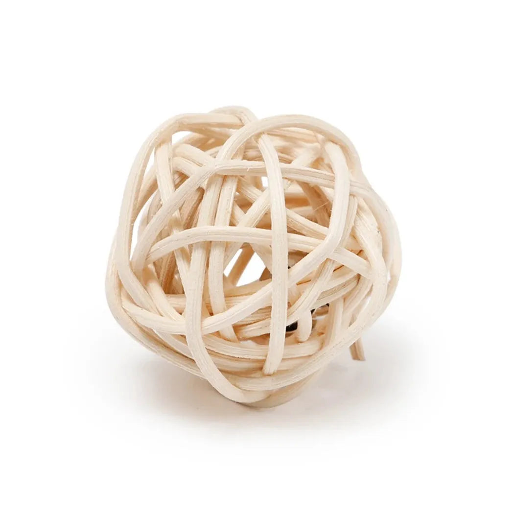 Two cat toys: hollow rattan ball and faux feather ball with bell attachment on neutral background