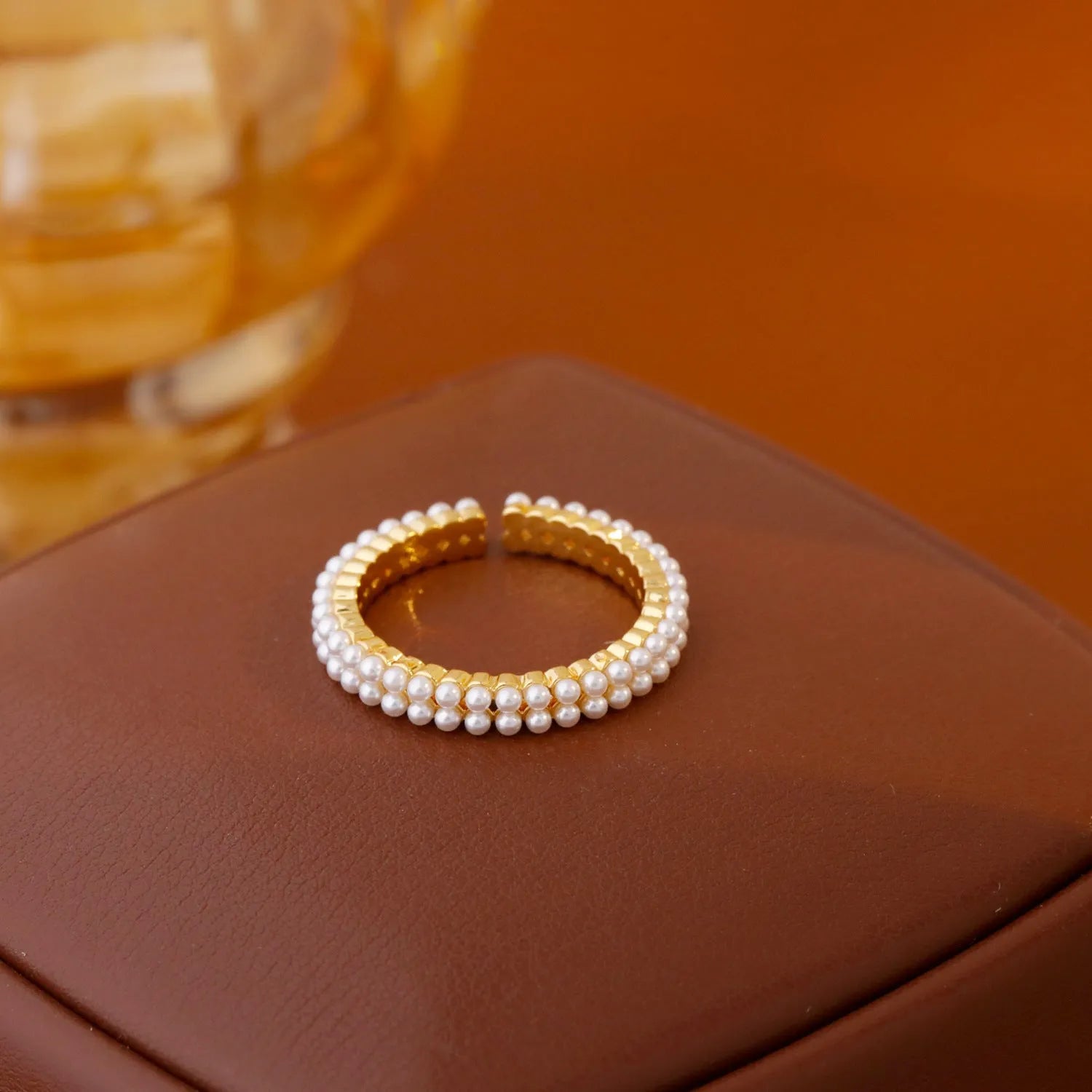Gold geometric open mouth women's ring with round pearl design elements on copper base