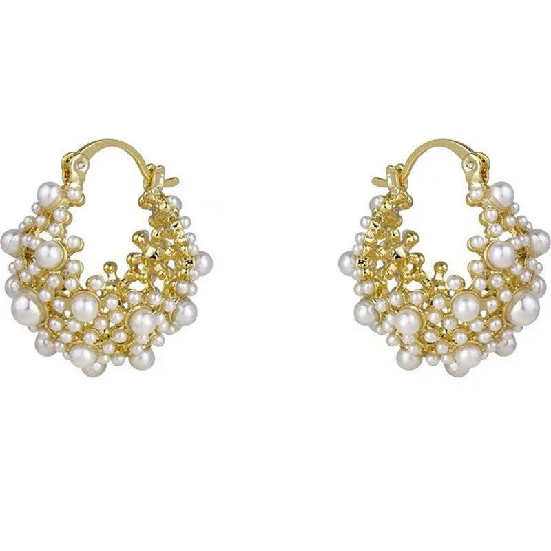 Gold tone copper flower basket shaped earrings with small rice-shaped pearl inlay beads.