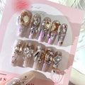 False nail patches with rhinestone embellishments in S number sizing on card paper packaging