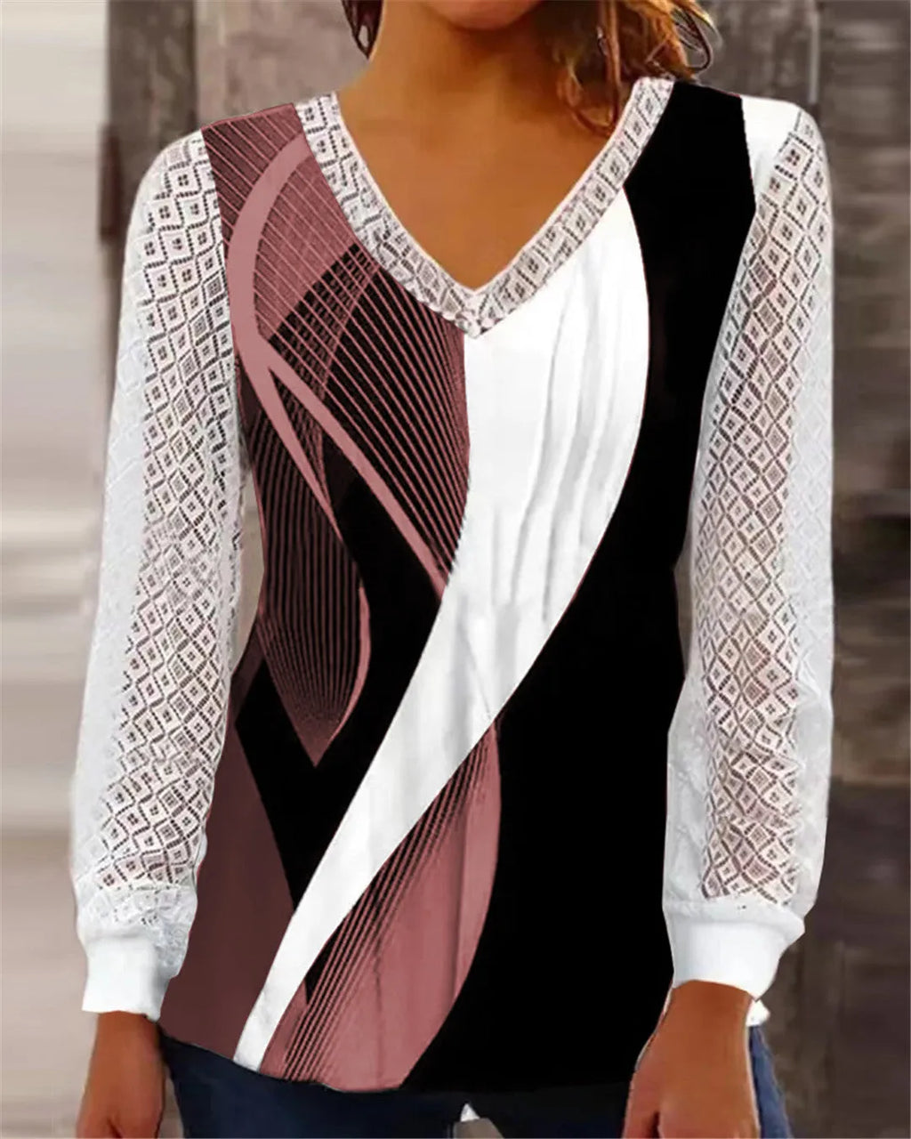 Women's loose purple V-neck pullover top with lace print and long sleeves on a hanger.