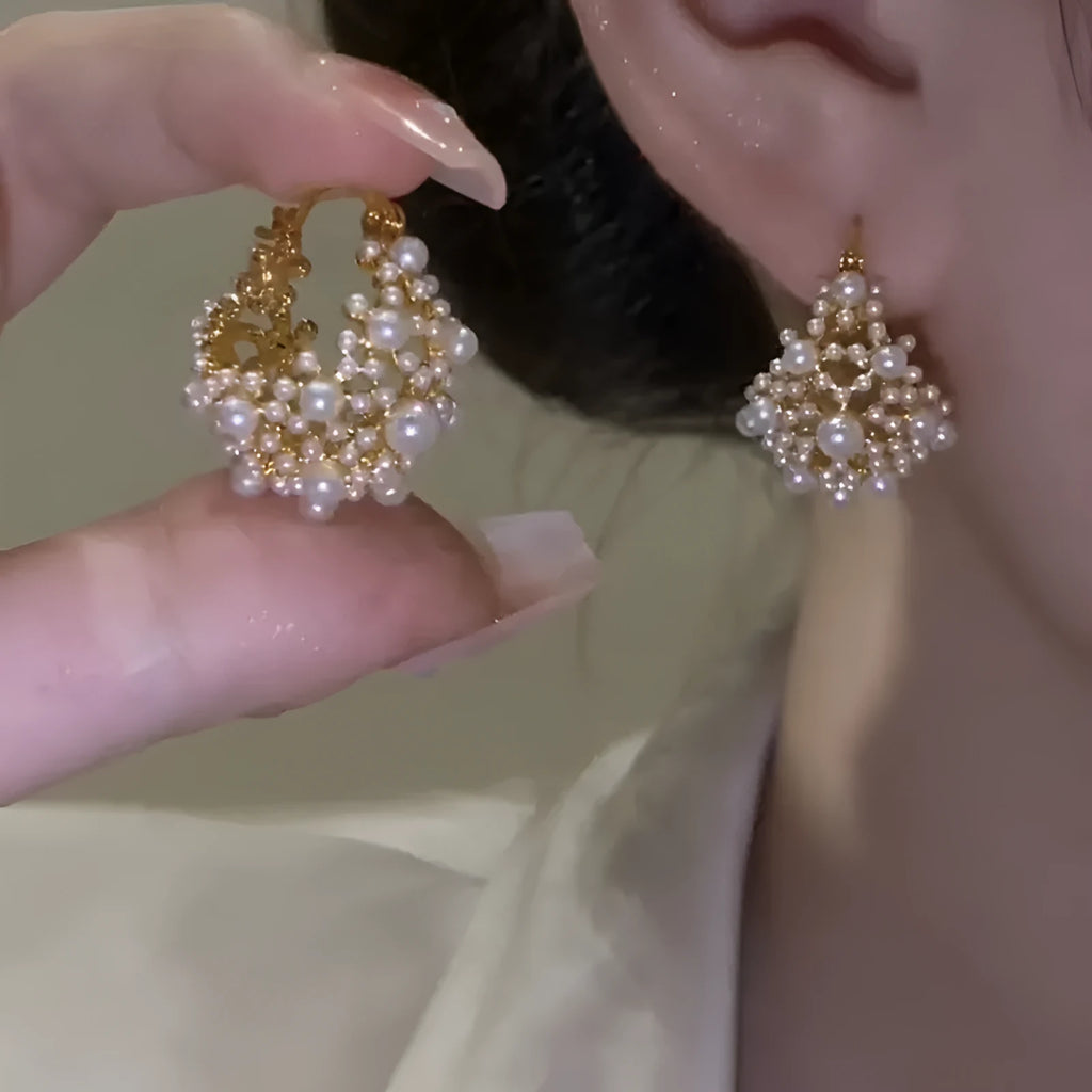 Gold tone copper flower basket shaped earrings with small rice-shaped pearl inlay beads.
