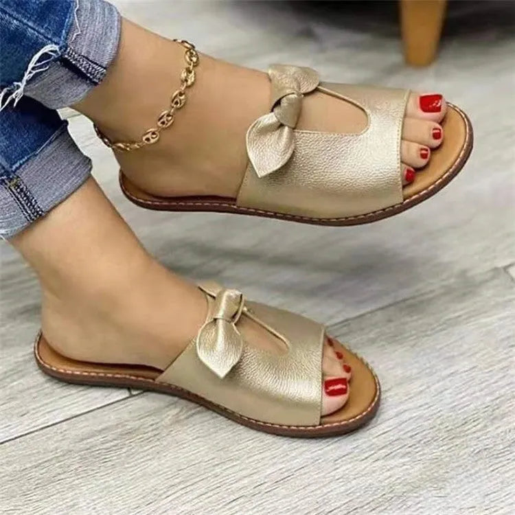 Women's black casual sandals with a fish mouth open toe and a decorative bow on the upper.