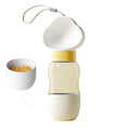 Portable dog water bottle with plastic body, rotary switch, and attached belt, showing water dispenser and bottom food container