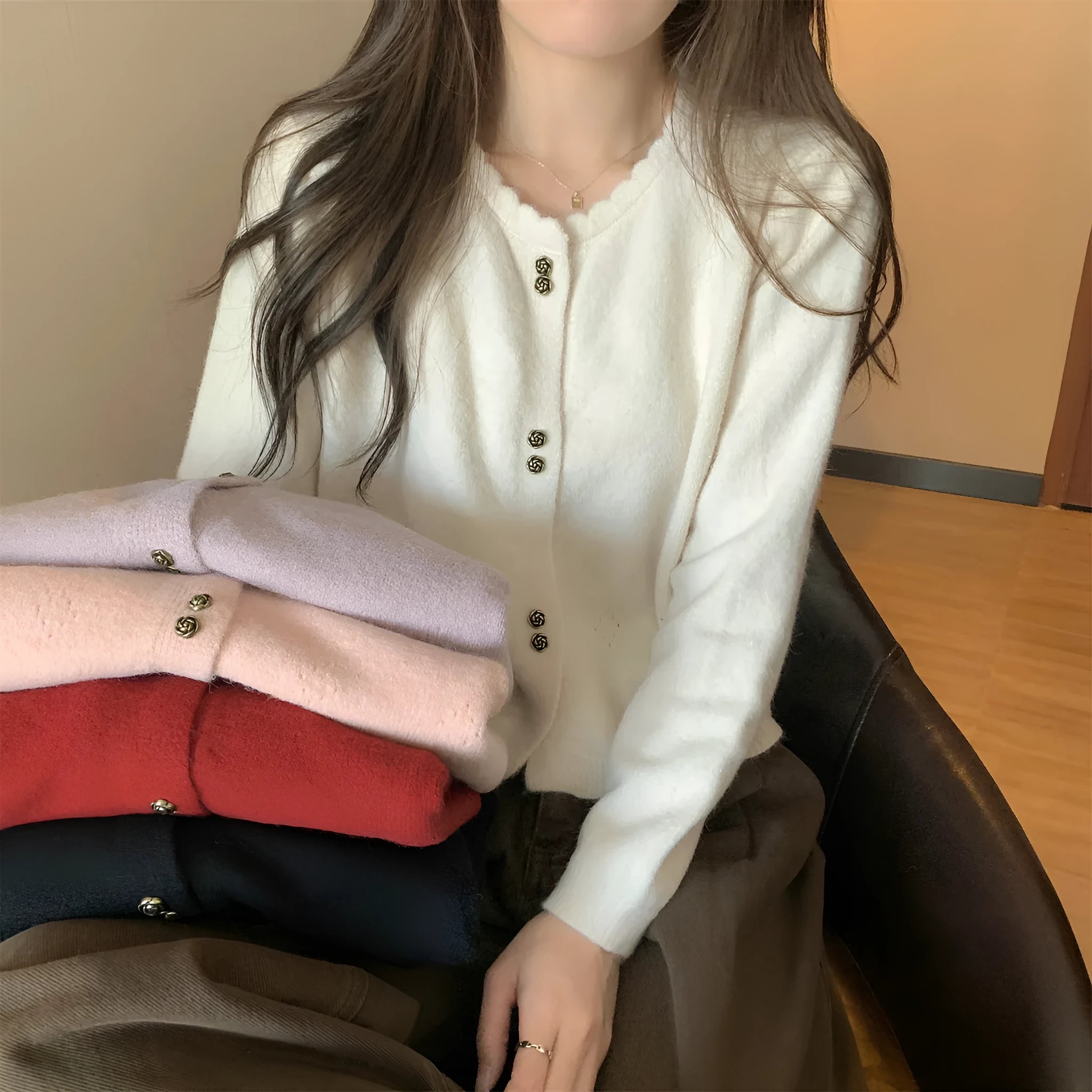 Women's acrylic cardigan sweater coat in milky white, shown with long sleeves and a cardigan front.