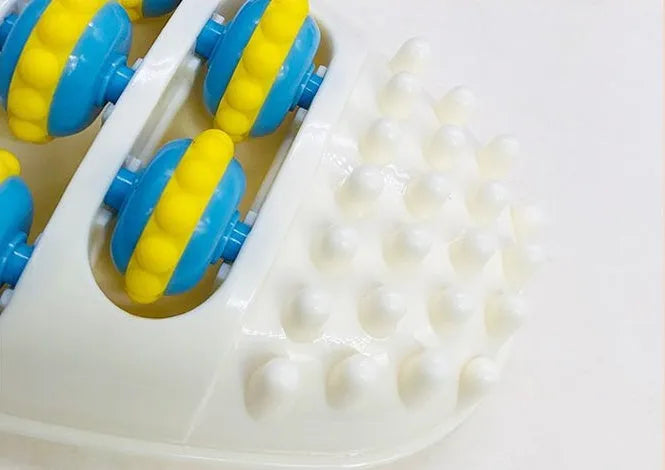 White dual foot acupressure massager roller for plantar fasciitis relief, with textured plastic surface