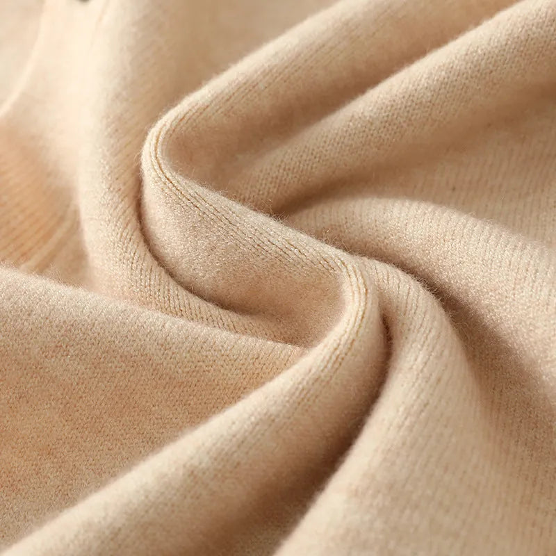 Man wearing a beige loose-fit V-neck Andy velvet knitted cardigan coat with long sleeves.